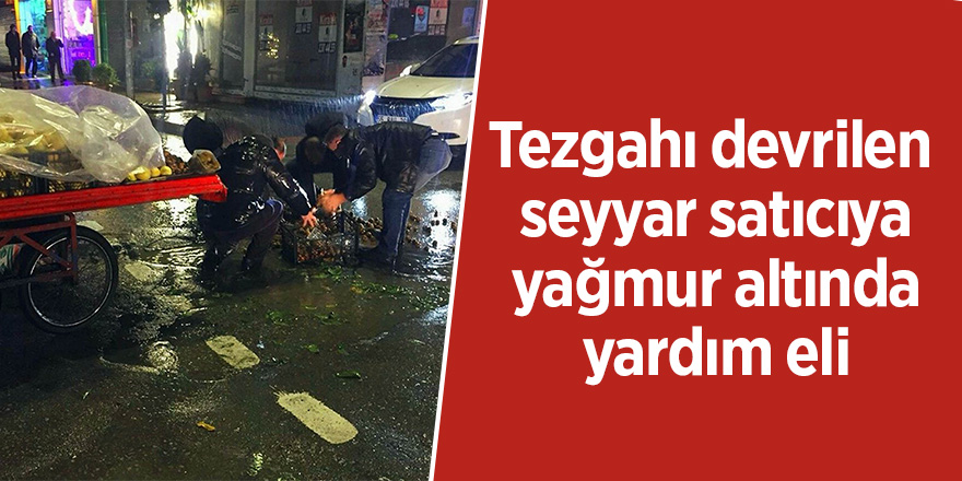 Tezgahı devrilen seyyar satıcıya, yağmur altında yardım eli