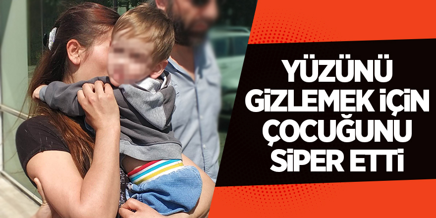 Yüzünü gizlemek için çocuğunu siper etti